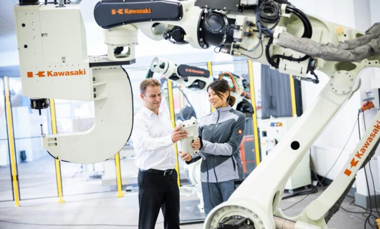 a man and a woman standing in front of a robot