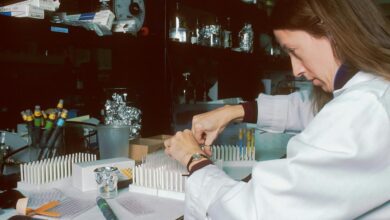 a woman in a lab coat is doing something