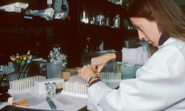 a woman in a lab coat is doing something