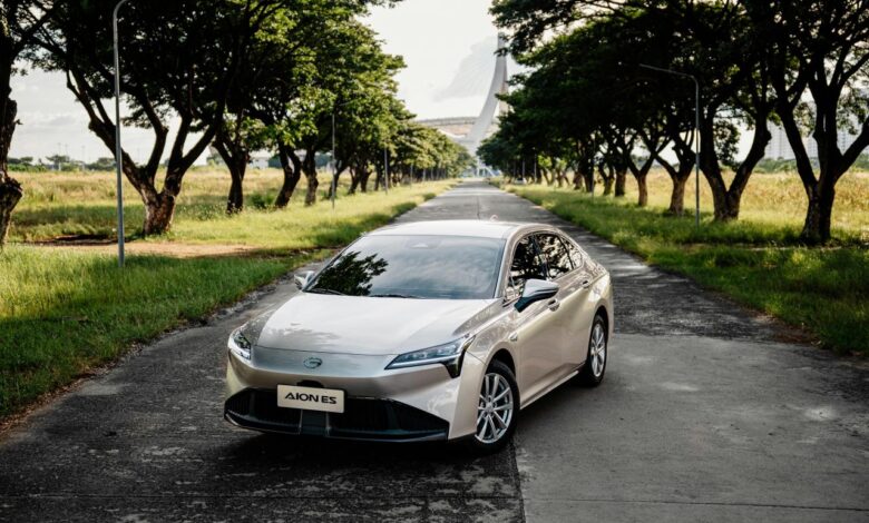 Silver sedan parked on a tree-lined road