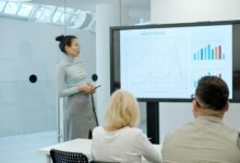 Woman presenting a graph to an audience